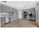 The kitchen is equipped with stainless steel appliances, grey cabinets, and tiled floor at 223 Royal Oaks Cir, Longwood, FL 32779