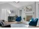 Stylish living room with brick fireplace, blue accents, and tile flooring at 223 Royal Oaks Cir, Longwood, FL 32779