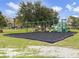 A playground with swings, a climbing structure, and a slide for Gathering fun in the community at 223 Royal Oaks Cir, Longwood, FL 32779
