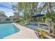 Inviting outdoor patio with shade umbrella and furniture is nestled next to a refreshing in-ground pool at 223 Royal Oaks Cir, Longwood, FL 32779