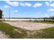 A lakeside sand volleyball court with picnic benches and a playground creates a fun community space at 223 Royal Oaks Cir, Longwood, FL 32779