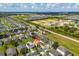 High aerial view showing neighborhood's layout, proximity to open fields, and overall community setting at 233 Cadiz Loop, Davenport, FL 33837
