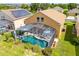 Expansive backyard with a screened-in pool, patio furniture, lush landscaping, and plenty of space for entertaining at 233 Cadiz Loop, Davenport, FL 33837