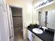 Bathroom featuring a white sink and vanity with dark countertop, and a view into the shower/tub at 233 Cadiz Loop, Davenport, FL 33837