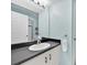 Light and airy bathroom with white vanity, dark countertop, and blue walls at 233 Cadiz Loop, Davenport, FL 33837