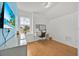 Bright bedroom with a white desk and chair, a television, and a large window at 233 Cadiz Loop, Davenport, FL 33837