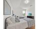 Bedroom featuring two beds with metal frames and white and patterned covers, and a window at 233 Cadiz Loop, Davenport, FL 33837
