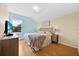 Bedroom featuring a queen bed, an aqua blue wall, and light yellow walls at 233 Cadiz Loop, Davenport, FL 33837