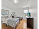 Bedroom featuring two beds with metal frames, neutral patterned covers, a side table and a window at 233 Cadiz Loop, Davenport, FL 33837