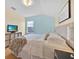 Bedroom featuring a queen bed, an aqua blue wall, and light yellow walls at 233 Cadiz Loop, Davenport, FL 33837
