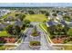 Landscaped community entrance with manicured gardens, palm trees, and a central sign for a welcoming feel at 233 Cadiz Loop, Davenport, FL 33837