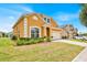 Attractive home with lush green lawn, beautiful landscaping, and a two-car garage at 233 Cadiz Loop, Davenport, FL 33837