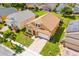 Well-maintained two-story home with a manicured lawn, brick driveway, and a charming front garden at 233 Cadiz Loop, Davenport, FL 33837
