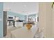 Open-concept kitchen with white cabinets, black countertops, and seamless flow into the dining and living areas at 233 Cadiz Loop, Davenport, FL 33837