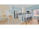 Bright eat-in kitchen with stainless steel appliances, breakfast bar, and crisp white cabinetry at 233 Cadiz Loop, Davenport, FL 33837