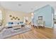 Bright and airy living room featuring hardwood floors, contemporary furniture, and plenty of natural light at 233 Cadiz Loop, Davenport, FL 33837