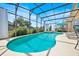 Inviting screened-in pool with turquoise water, lounge chairs, and privacy curtains, perfect for relaxation at 233 Cadiz Loop, Davenport, FL 33837