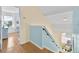 Stairway that merges light and neutral tones, showcasing modern design at 233 Cadiz Loop, Davenport, FL 33837