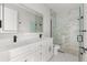 Bathroom featuring a marble walk-in shower and double sink vanity with elegant fixtures at 2446 Greenway, Sanford, FL 32771