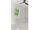 Bedroom features modern ceiling fan, white marble floors, and view from a large window at 2446 Greenway, Sanford, FL 32771