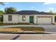 Charming one-story home boasts a teal front door and a well-manicured lawn at 2446 Greenway, Sanford, FL 32771