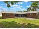 This backyard features a well-maintained lawn, mature trees, and a screen patio at 247 Carmen Ln, Debary, FL 32713