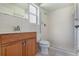 A bathroom features a tiled shower, and a single sink vanity at 247 Carmen Ln, Debary, FL 32713