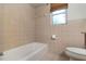 Bathroom featuring decorative tile accents and a shower-tub combination at 247 Carmen Ln, Debary, FL 32713