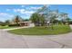 Exterior view of home with an expansive lawn, mature trees, and a side-entry two-car garage at 247 Carmen Ln, Debary, FL 32713