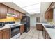 Kitchen featuring wood cabinets, tile floors, stainless steel appliances, and white countertops at 247 Carmen Ln, Debary, FL 32713