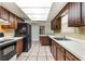Classic kitchen featuring ample cabinetry, white countertops and tile backsplash, and modern appliances at 247 Carmen Ln, Debary, FL 32713