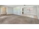 Spacious living room with carpet and tile floors with neutral paint and an open floor plan at 247 Carmen Ln, Debary, FL 32713