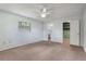 Main bedroom with carpet, a ceiling fan, a closet, and an en suite bathroom at 247 Carmen Ln, Debary, FL 32713