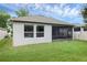 Manicured backyard features a well-maintained lawn and view of the screened-in patio at 2829 Red Alder Blvd, Ocoee, FL 34761