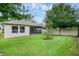 Landscaped backyard shows a manicured lawn and a screened-in patio at 2829 Red Alder Blvd, Ocoee, FL 34761