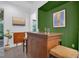 An entertaining bar features wooden construction and seating, accented by contemporary art pieces and neutral tones at 2829 Red Alder Blvd, Ocoee, FL 34761
