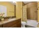 Bright bathroom boasts a wood-look accent wall, tub-shower combo, and granite countertop vanity at 2829 Red Alder Blvd, Ocoee, FL 34761