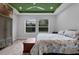 Relaxing bedroom with natural light, wood tile flooring, and a decorative ceiling at 2829 Red Alder Blvd, Ocoee, FL 34761