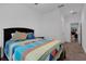 Cozy bedroom with a vibrant quilt, and ample closet space at 2829 Red Alder Blvd, Ocoee, FL 34761