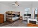 A functional bedroom with bunk beds, workspace and ceiling fan at 2829 Red Alder Blvd, Ocoee, FL 34761