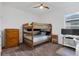Cozy bedroom features a wooden bunk bed, dresser, and neutral carpeting at 2829 Red Alder Blvd, Ocoee, FL 34761
