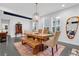Bright dining room features a wooden table, chandelier, and large windows at 2829 Red Alder Blvd, Ocoee, FL 34761