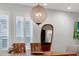 Dining room with a wooden table, modern light fixture, and natural light at 2829 Red Alder Blvd, Ocoee, FL 34761