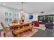 Open-concept dining area with wooden table, chandelier, and access to living area at 2829 Red Alder Blvd, Ocoee, FL 34761