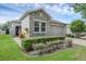 Lovely home showcasing a stone facade, a well-maintained lawn, and a two-car garage with a brick driveway at 2829 Red Alder Blvd, Ocoee, FL 34761