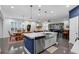 Open-concept kitchen with stainless appliances flowing into the living and dining area at 2829 Red Alder Blvd, Ocoee, FL 34761