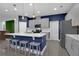 Modern kitchen featuring a large island, stainless steel appliances, and gray cabinetry at 2829 Red Alder Blvd, Ocoee, FL 34761