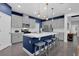 Stylish kitchen with stainless steel appliances, gray cabinets, white countertops, and a blue accent island at 2829 Red Alder Blvd, Ocoee, FL 34761