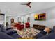 Spacious living room features modern furniture, a ceiling fan, and ample lighting at 2829 Red Alder Blvd, Ocoee, FL 34761