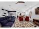 Bright and open living space featuring a comfortable sofa, stylish chairs, modern decor, and an open-concept layout at 2829 Red Alder Blvd, Ocoee, FL 34761